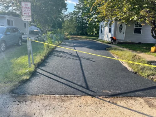 RSA driveway paving company in Maryland completed driveway paving project in neighborhood with caution tape up.