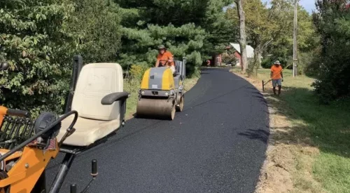 Asphalt contractor crew paving a driveway in Maryland.
